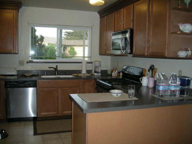 3083 Messinger Drive Marina, CA 93933 - Photo 9 of 18 a kitchen with sink a microwave and cabinets