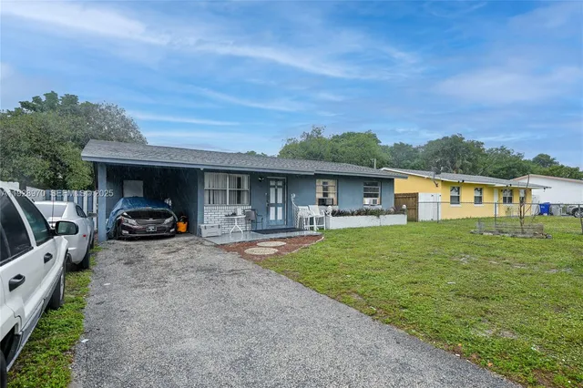 a front view of a house with a yard table and chairs
