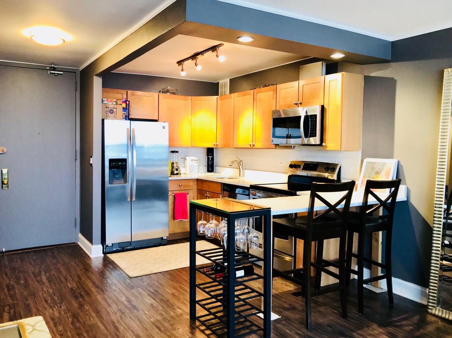 655 West Irving Park Road, Unit 2911 Chicago, IL 60613 - Photo 15 of 42 a kitchen with stainless steel appliances kitchen island granite countertop a dining table chairs and a large window