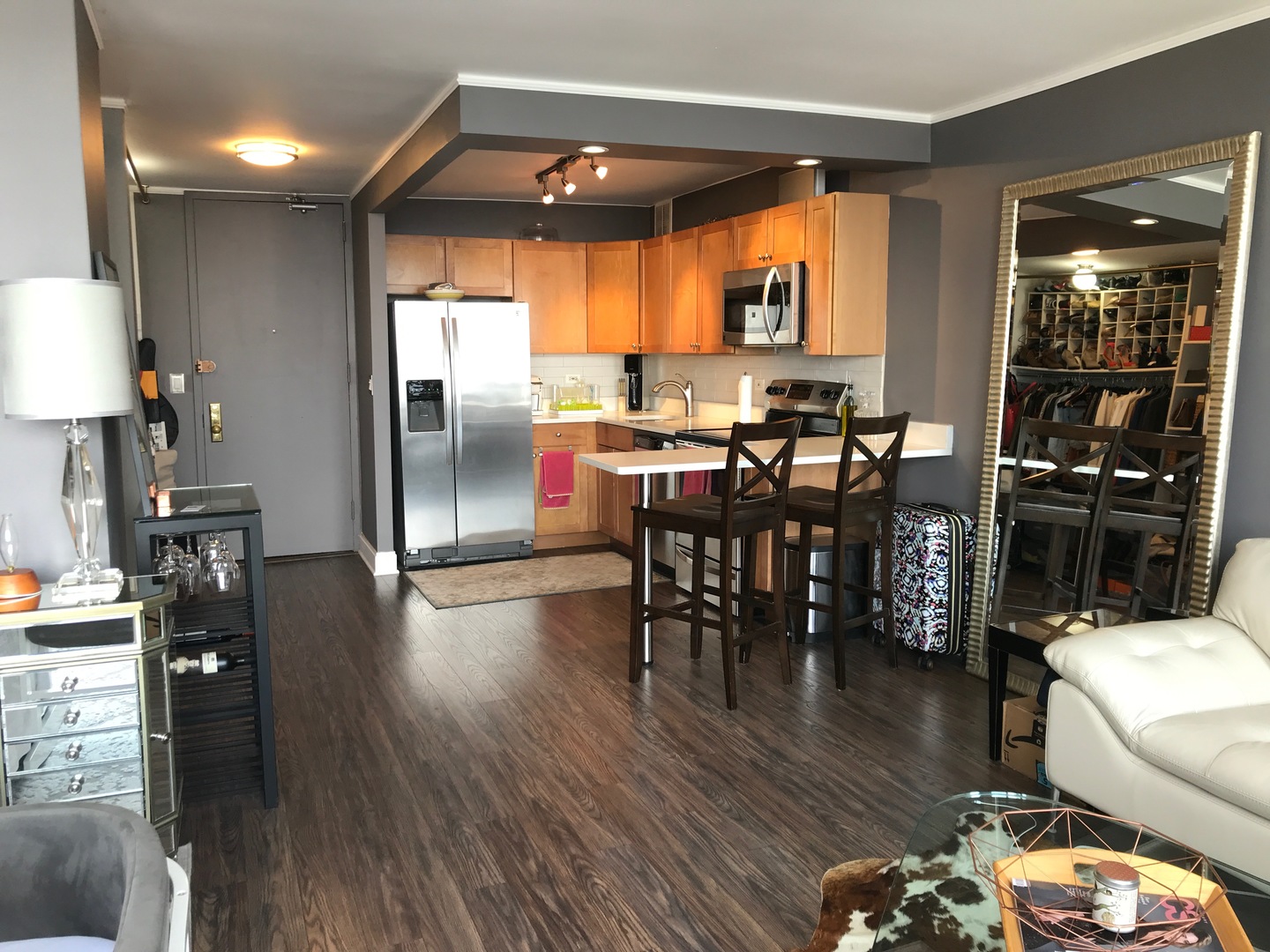 655 West Irving Park Road, Unit 2911 Chicago, IL 60613 - Photo 17 of 42 a kitchen with stainless steel appliances wooden floor dining table and chairs