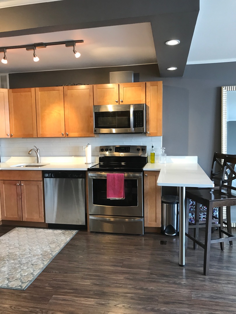 655 West Irving Park Road, Unit 2911 Chicago, IL 60613 - Photo 20 of 42 a kitchen with a stove and a microwave