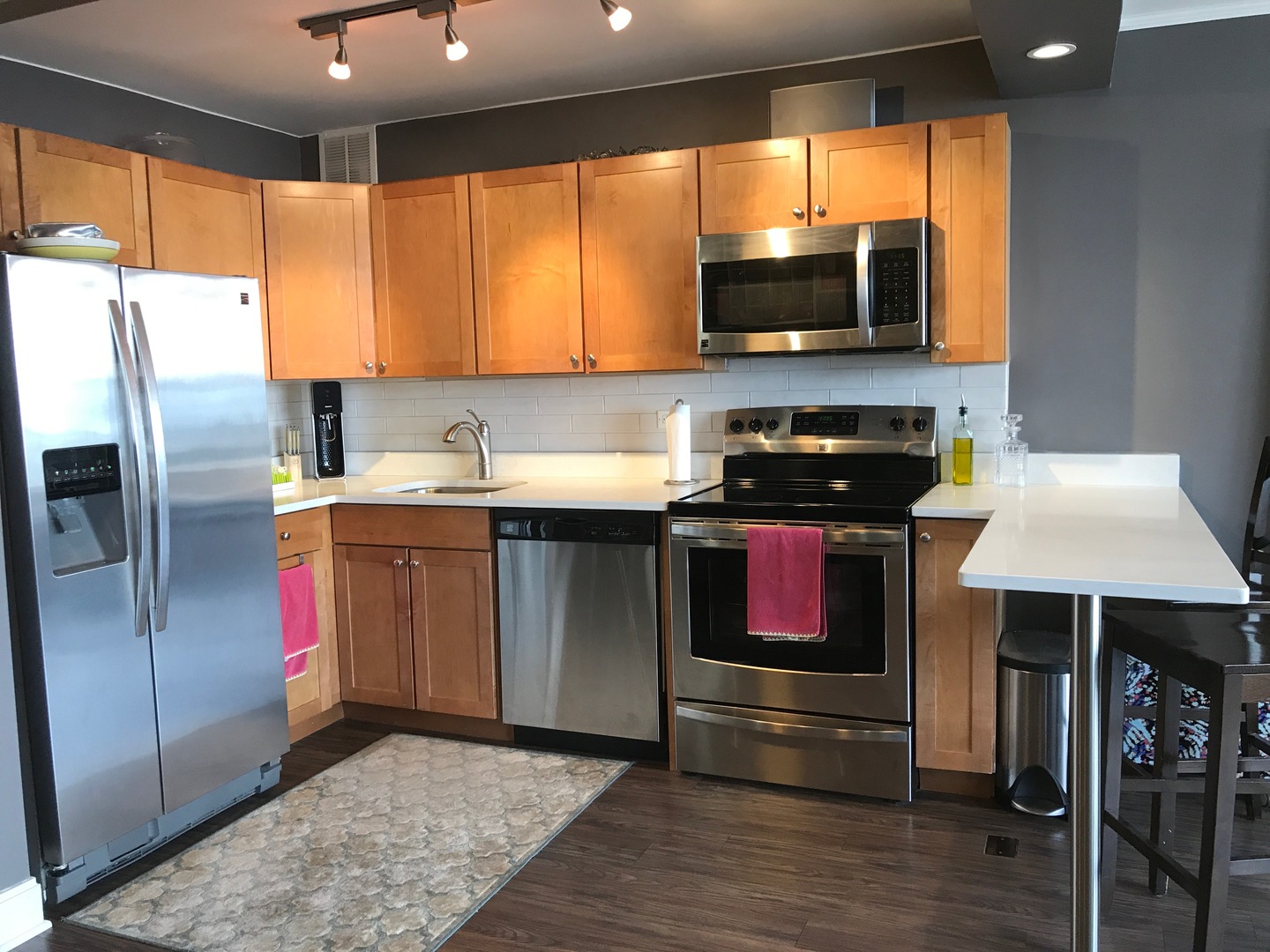 655 West Irving Park Road, Unit 2911 Chicago, IL 60613 - Photo 21 of 42 a kitchen with granite countertop a stove a sink and a microwave