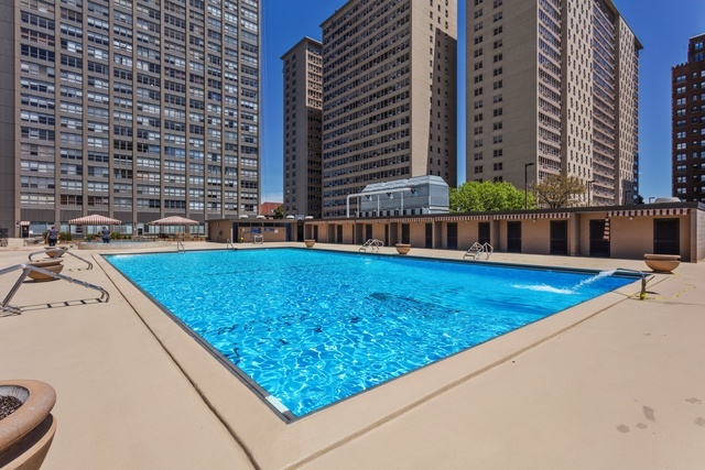 655 West Irving Park Road, Unit 2911 Chicago, IL 60613 - Photo 8 of 42 a view of a swimming pool with a chairs