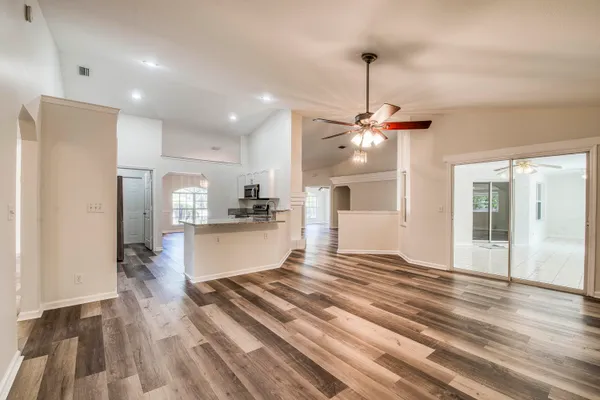 a view of kitchen and hall with wooden floor