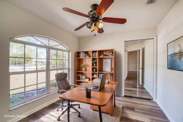 a view of a workspace with furniture and a window