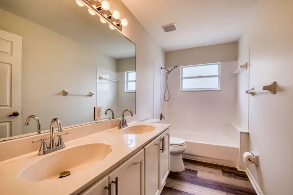 a bathroom with a sink a toilet and a bathtub