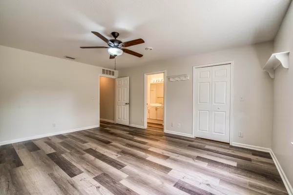 a view of a livingroom with a ceiling fan and window