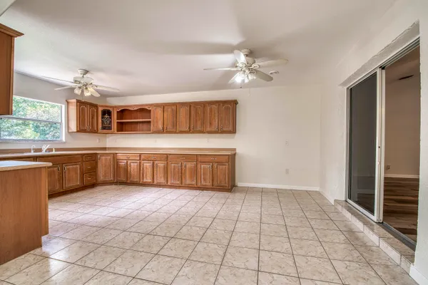 a open kitchen with stainless steel appliances a sink cabinets and window