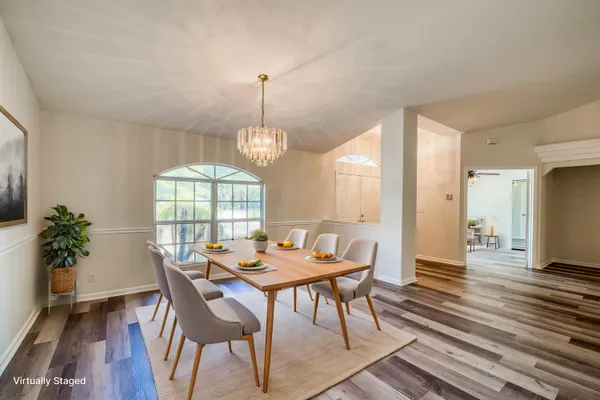 a view of a dining room with furniture window and wooden floor