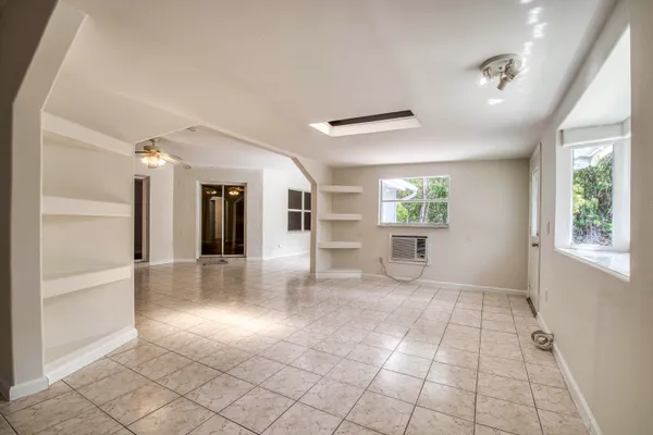 a view of a hallway with furniture and a window