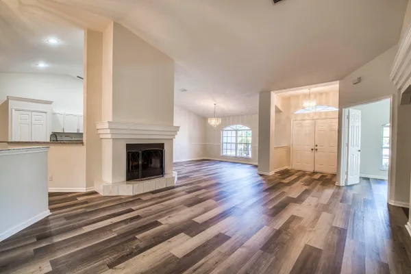 a view of a room with wooden floor and fireplace