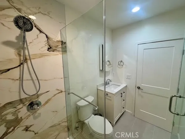 a bathroom with a shower and a sink