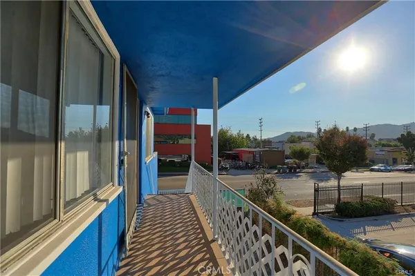 a balcony with view of living room