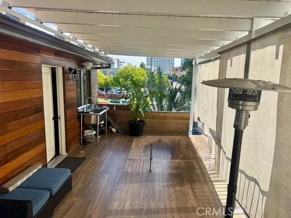 a porch with seating space and hardwood floor