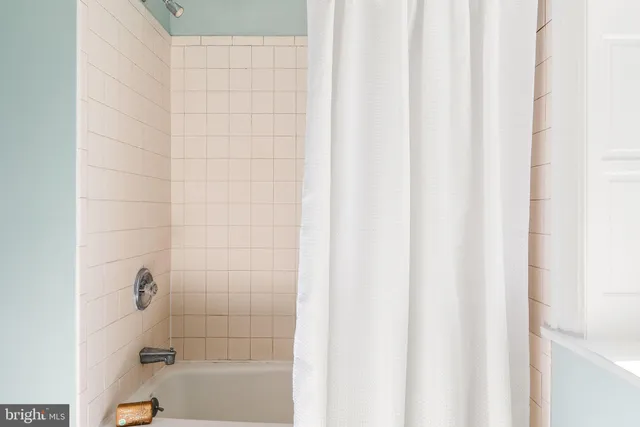 a bathroom with a shower and a bathtub