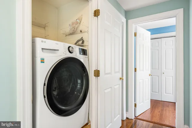 a view of a hallway with washer and dryer