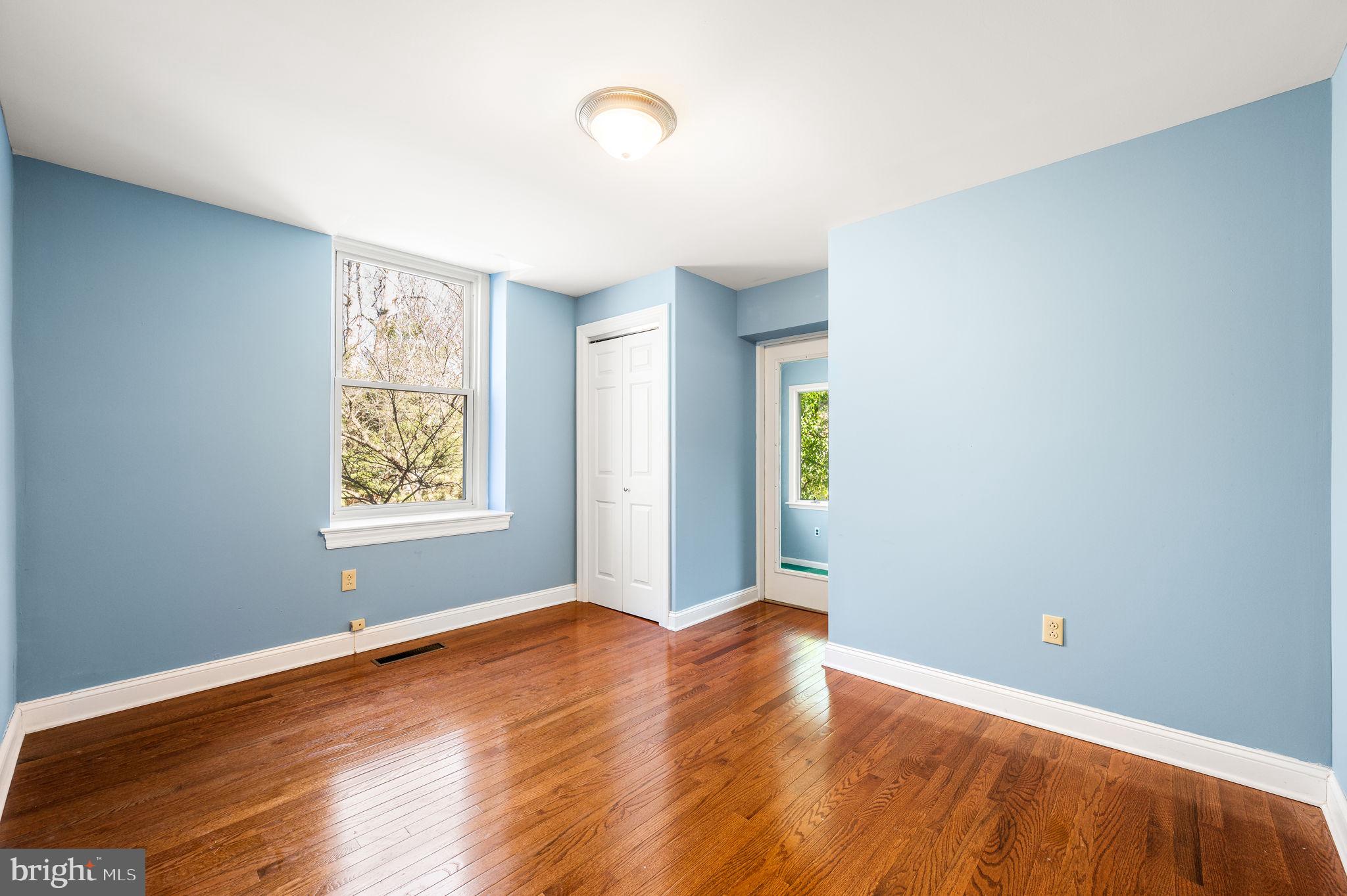 519 Walnut Lane, Unit 1 Swarthmore, PA 19081 - Photo 20 of 31 an empty room with wooden floor and windows