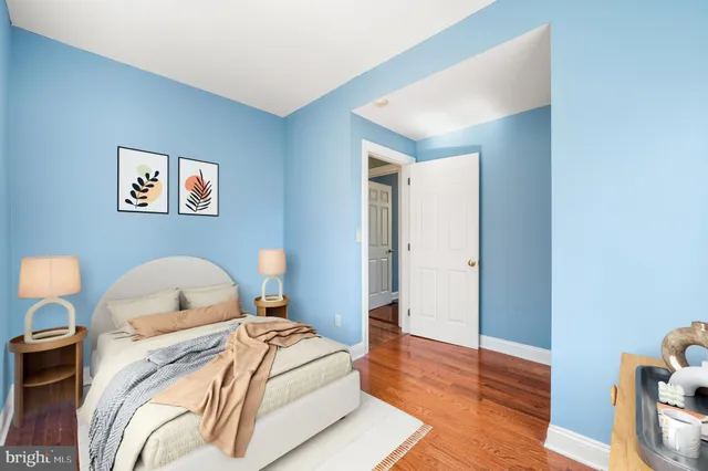 a bedroom with a bed and a night stand