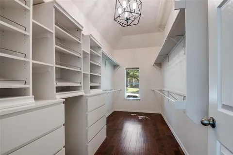 a view of a hallway with wooden floor and entryway