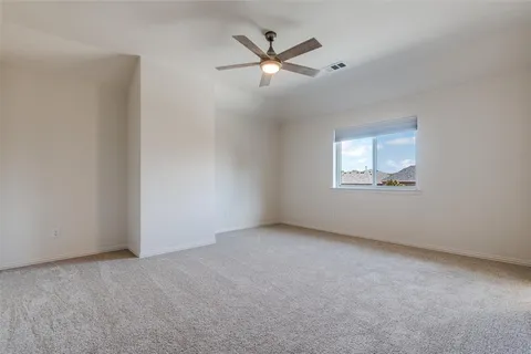 an empty room with closet and windows