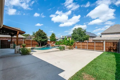 a view of a backyard with sitting area