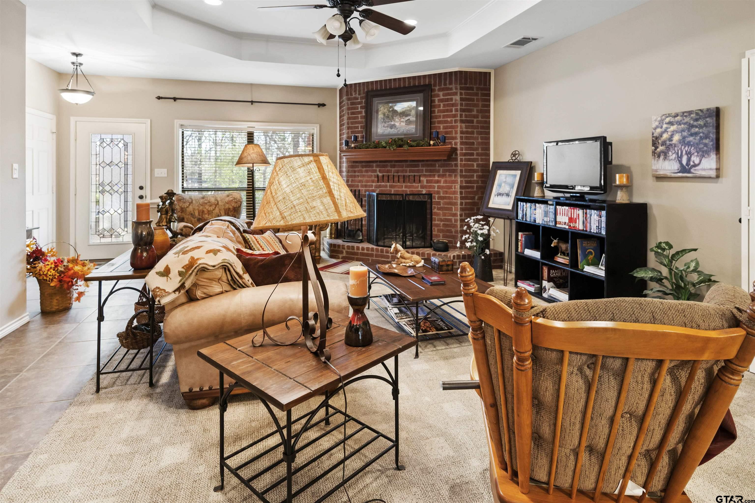 175 Old Gate Path Holly Lake Ranch, TX 75755 - Photo 7 of 28 a room with furniture a flat screen tv and a fireplace