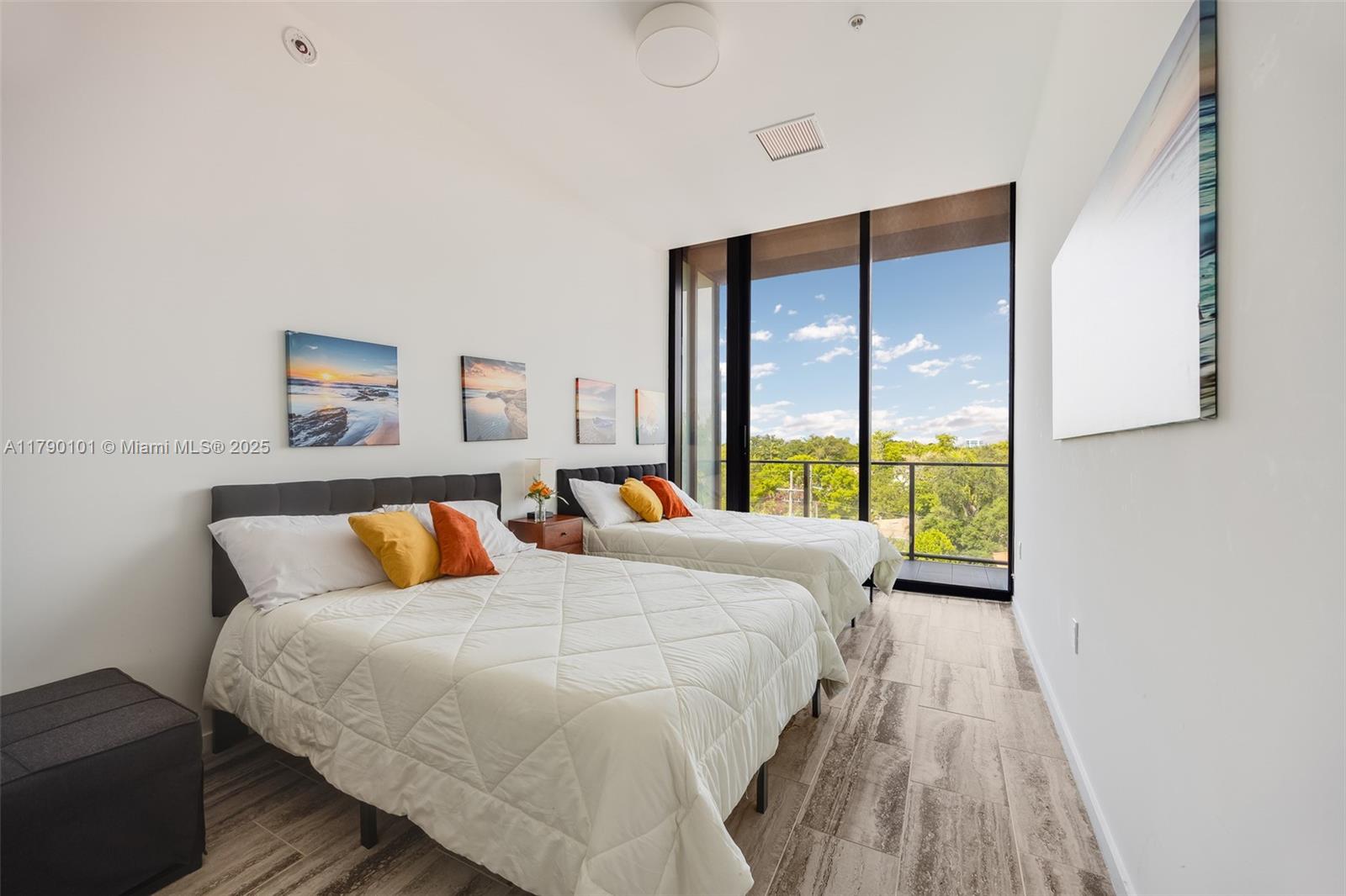 3156 Southwest 27th Avenue, Unit 402 Miami, FL 33133 - Photo 13 of 28 a bed room with a bed and a large window