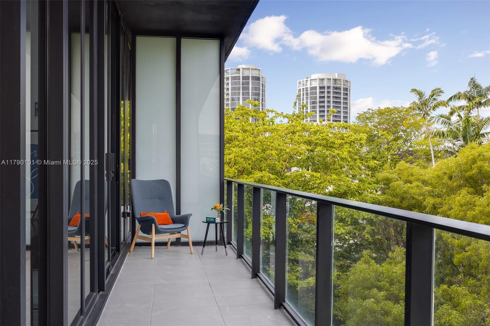 3156 Southwest 27th Avenue, Unit 402 Miami, FL 33133 - Photo 6 of 28 a view of a balcony with chairs
