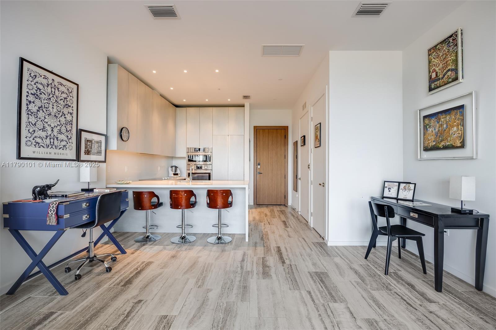 3156 Southwest 27th Avenue, Unit 402 Miami, FL 33133 - Photo 8 of 28 a living room with dining room and wooden floor