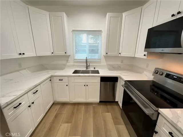 a kitchen with a sink stove and microwave