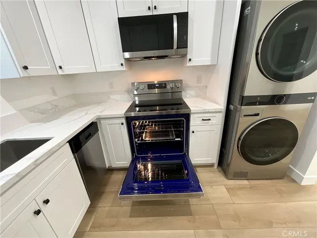 a kitchen with a stove and a washing machine