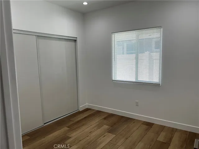 a view of a room with wooden floor and small staircase