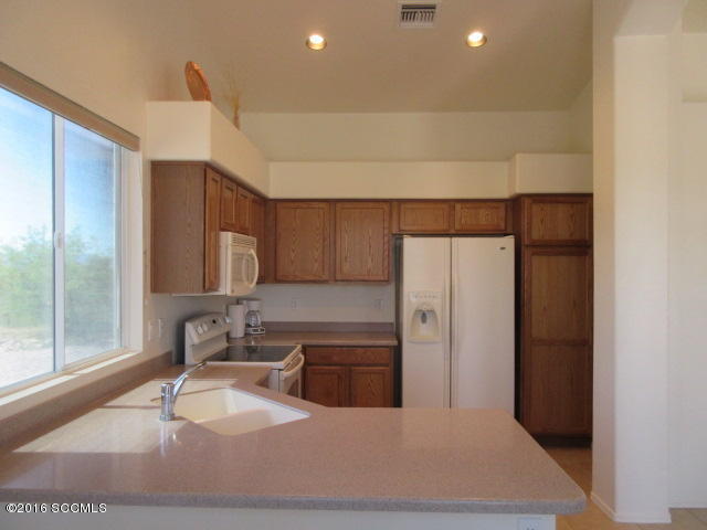 1881 Via Ochoa Rio Rico, AZ 85648 - Photo 26 of 44 a kitchen with stainless steel appliances a sink and a refrigerator