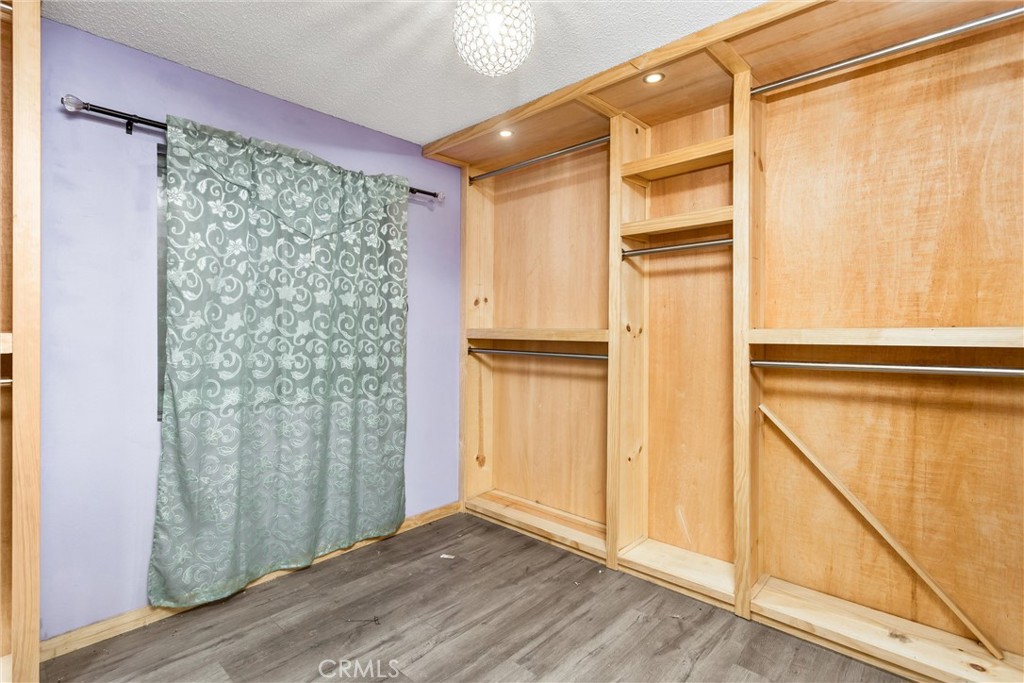 450 West Cromwell Street Rialto, CA 92376 - Photo 20 of 35 Bedroom #1 has laminate flooring, lots of built in closet/shelves