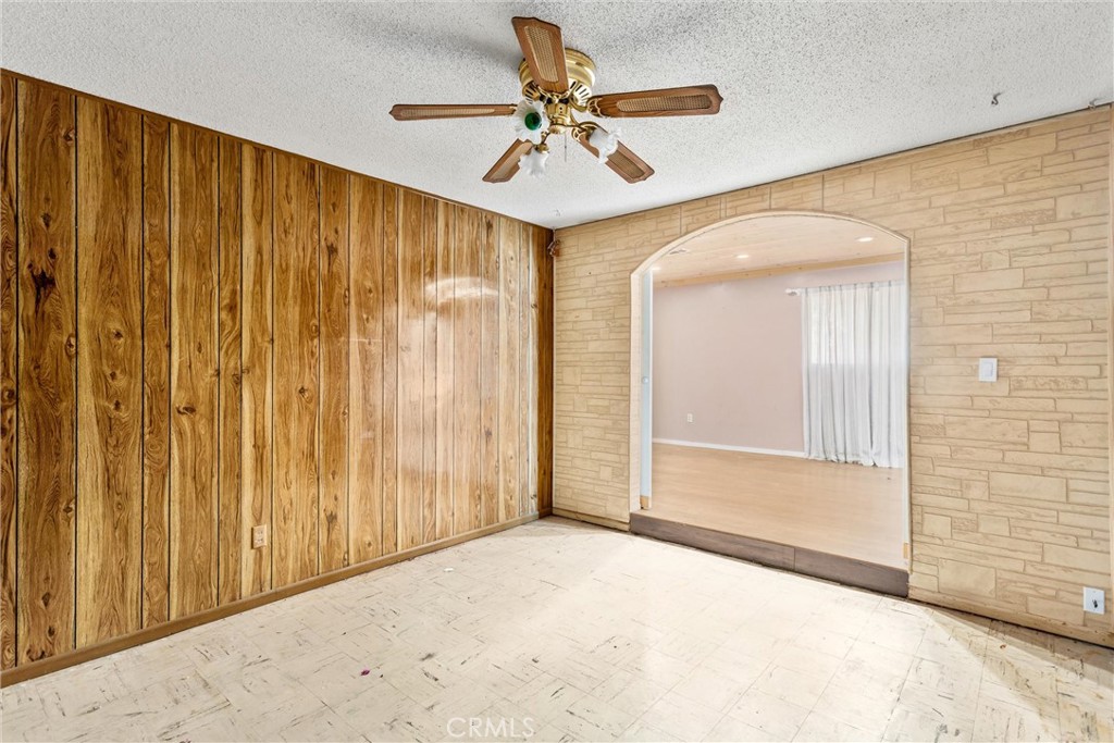450 West Cromwell Street Rialto, CA 92376 - Photo 28 of 35 4th bedroom with entrance to bonus room. Tiled flooring, paneling, ceiling fan