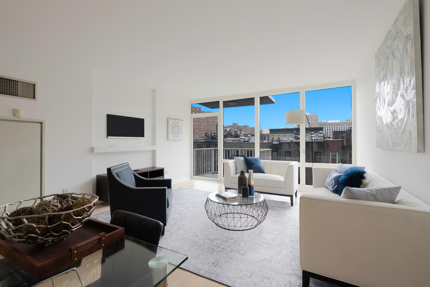 340 East 23rd Street, Unit 5M Manhattan, NY 10010 - Photo 1 of 15 a living room with furniture and a floor to ceiling window