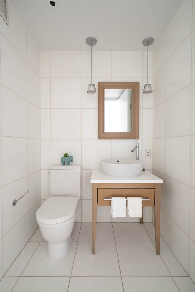 340 East 23rd Street, Unit 5M Manhattan, NY 10010 - Photo 12 of 15 a bathroom with a toilet a sink and mirror