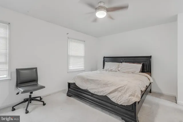 a bedroom with a bed and a desk