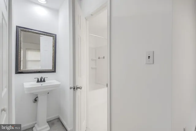 a bathroom with a sink mirror and vanity