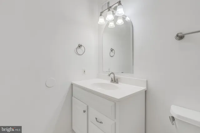 a bathroom with a sink vanity and mirror