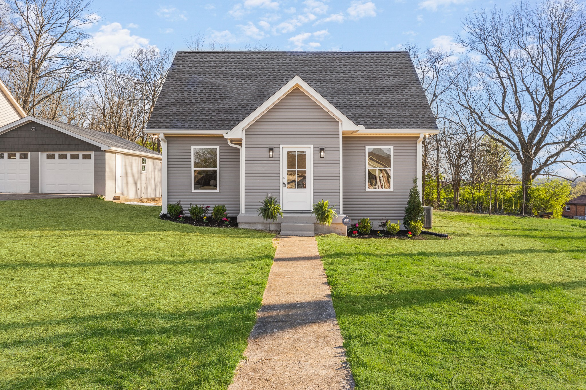 a front view of house with yard and green space