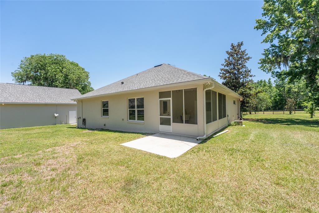 4735 Southeast 112th Street Road Belleview, FL 34420 - Photo 43 of 73 a front view of house with yard and trees in the background
