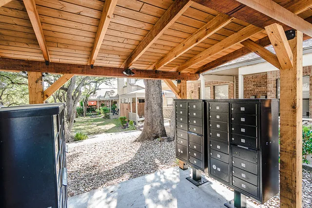 a view of a backyard with wooden fence and a porch