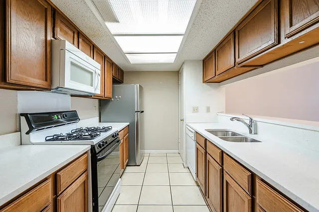 a kitchen with stainless steel appliances granite countertop a stove and a sink