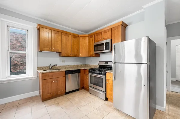a kitchen with stainless steel appliances granite countertop a refrigerator stove a sink and a refrigerator
