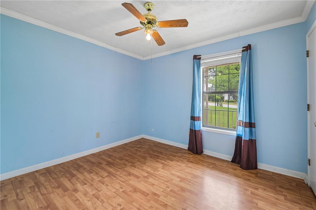 1318 Panhandle Way Hampton, GA 30228 - Photo 15 of 22 an empty room with windows and fan