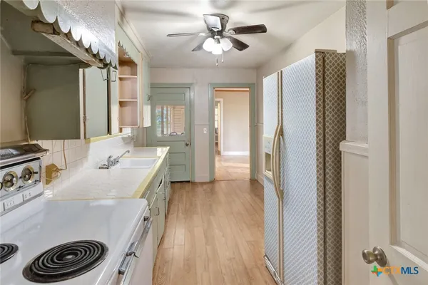 a view of a kitchen from the hallway