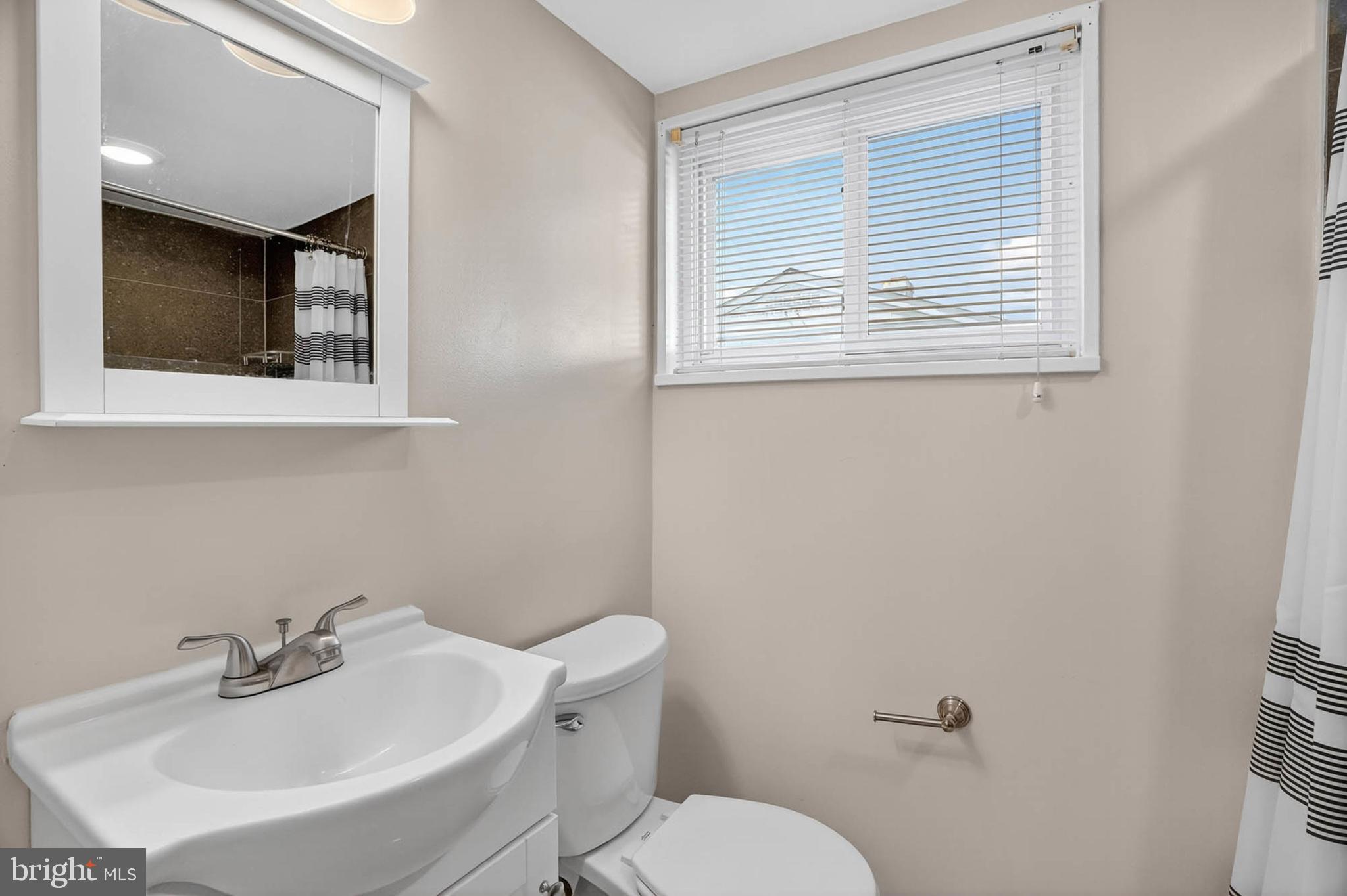 920 Vanderwood Road Catonsville, MD 21228 - Photo 19 of 25 a bathroom with a toilet sink and mirror