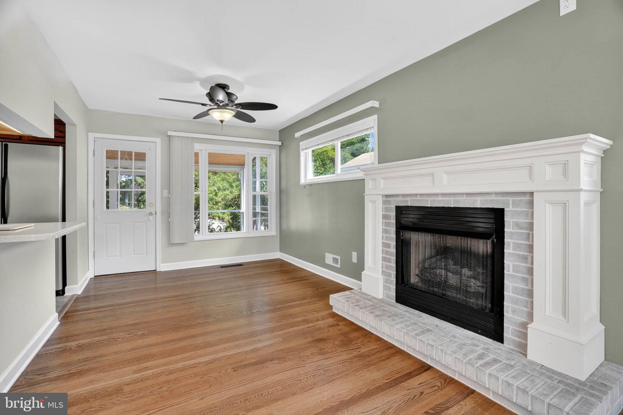 920 Vanderwood Road Catonsville, MD 21228 - Photo 6 of 25 a view of an empty room with wooden floor fireplace and a window