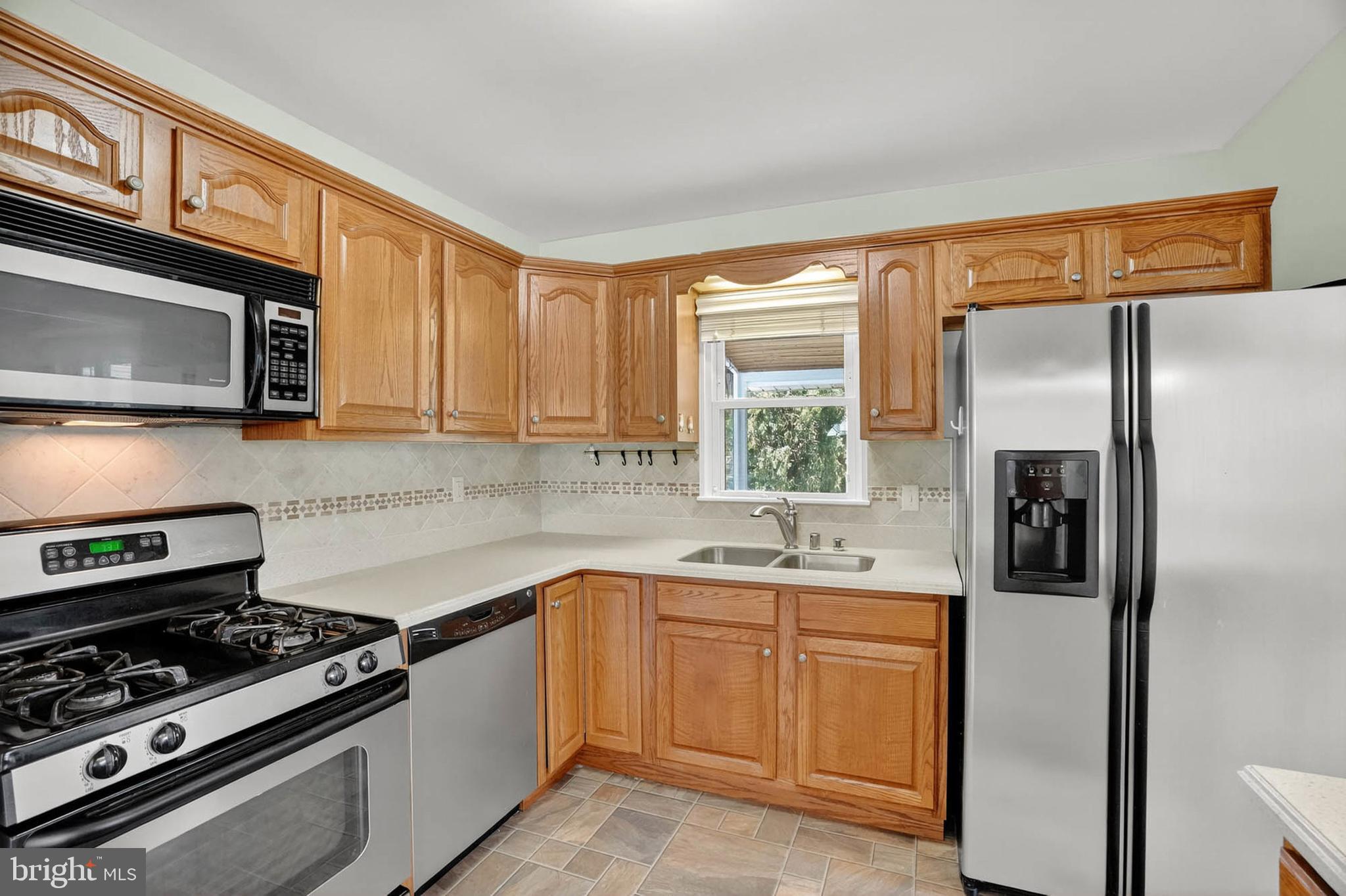 920 Vanderwood Road Catonsville, MD 21228 - Photo 9 of 25 a kitchen with a sink stove and refrigerator